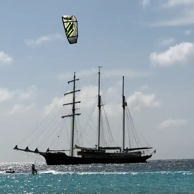 Sailing ship with kites surfer Klein Curaçao